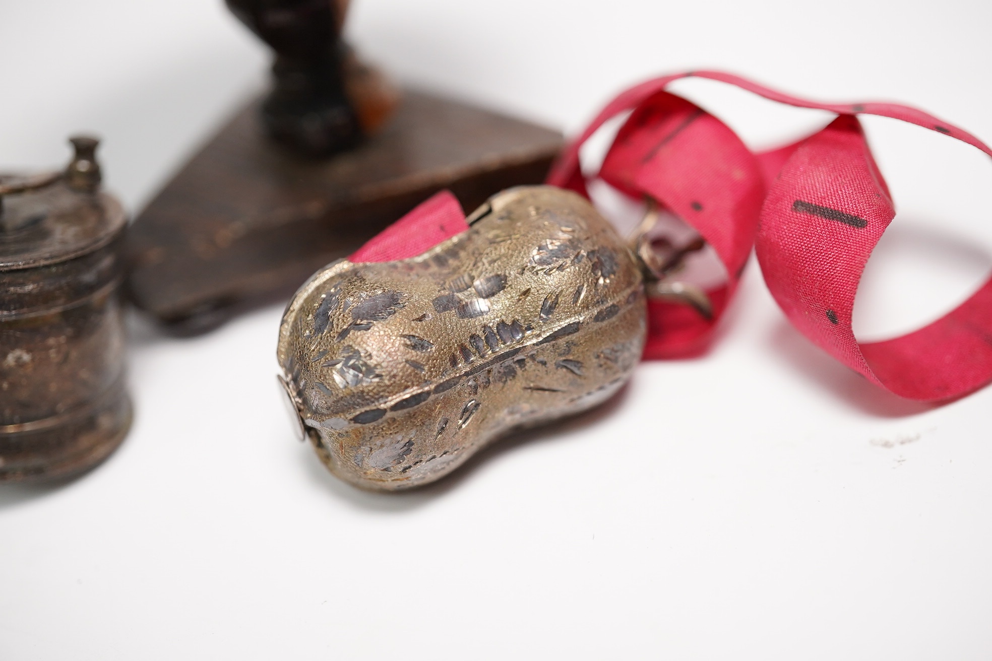 Two early Victorian white metal tape measures and a rosewood miniature 'table' pin cushion. Condition - fair